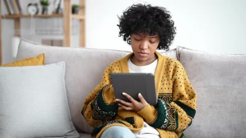 Young Person Relaxing at Home Using Tablet
