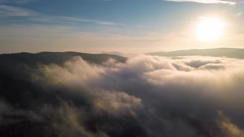 Aerial View of Mountains and Clouds at Sunrise