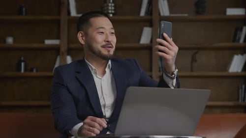 Businessman on a Video Conference Call Using Smartphone