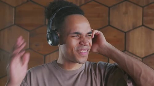 Young Adult Singing and Dancing with Headphones