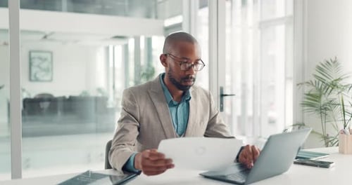 Reading, paperwork and man with laptop, office and typing financial analysis on website