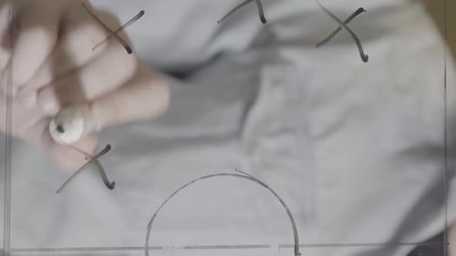 Vertical Video Close Up of Soccer Coach Drawing Tactics with Marker