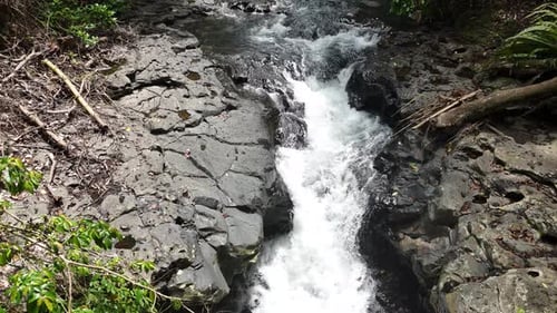 The river water flows clear between the rocks.