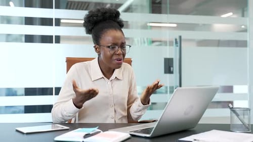 Woman Looking Stressed at Computer in Modern Office