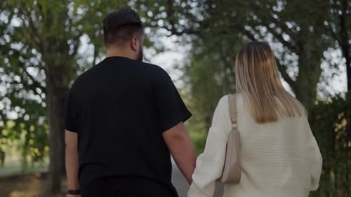 Young Couple Walking Together in a Picturesque Park