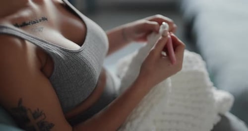 Woman Crochets a Blanket in Cozy Home Setting