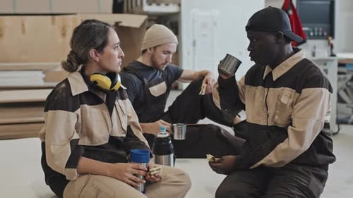 Factory Workers Chatting and Using Phone on Lunch
