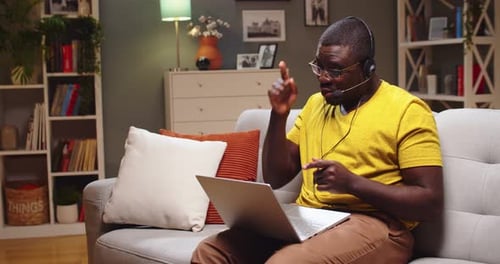 Man on Video Call Using Laptop at Home