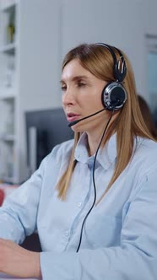 Professional Female Customer Support Agent Wearing Headset and Microphone While Assisting Clients in