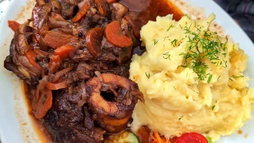 Beef Ossobucco Served With Polenta And Vegetables On Side. Lombard Cuisine. closeup, zoom-out