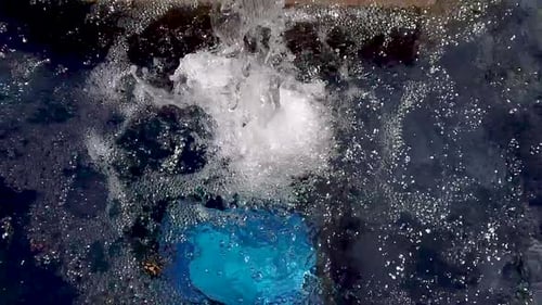 Streaming Water Fills Dark Blue Swimming Pool