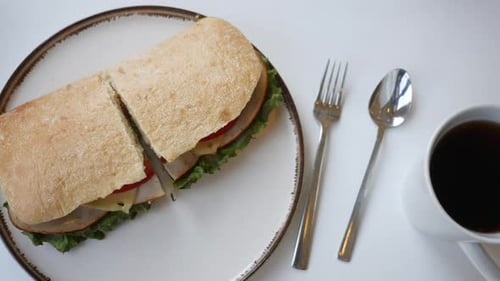 Enjoying a Delicious Sandwich with Coffee at a Cafe