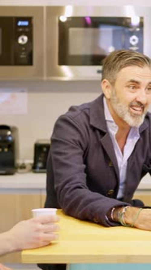 Relaxed Coworker During Coffee Break in a Cafeteria