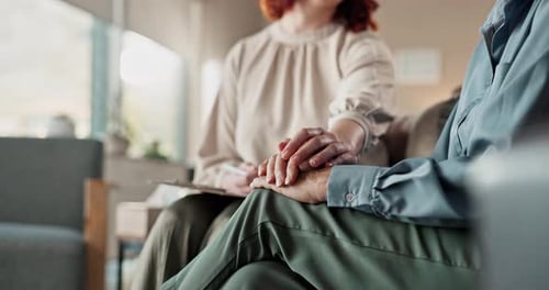 Supportive Woman Comforting Older Adult, Holding Hands