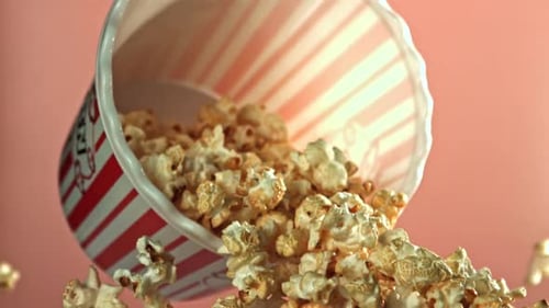 Popcorn spilling from container in slow motion