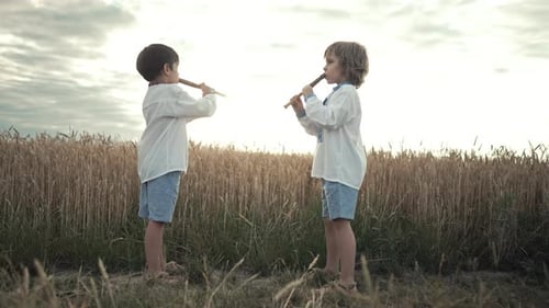 Petits garçons jouant de la musique folklorique sur des flûtes à vent ukrainiennes (Sopilka ou Tylynka)