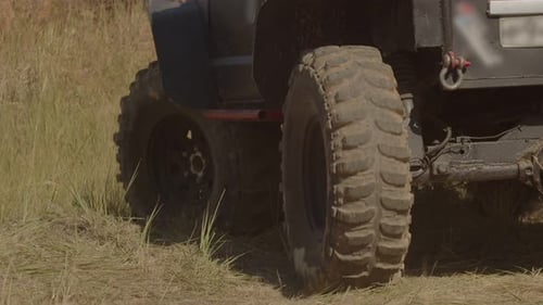 Closeup of Wheels of Suv Driving Back Along Desert Road Back View