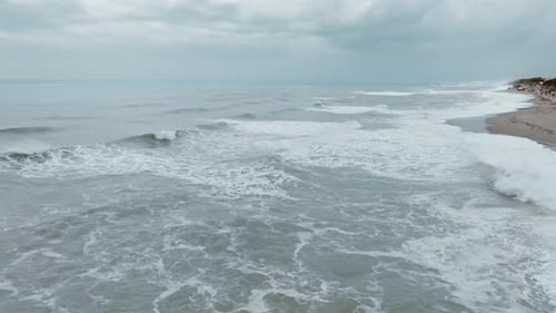 Foam Of The Waves In Italy Moving On A Cloudy Day