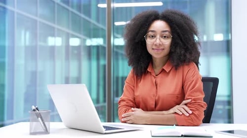 Young Professional Woman Smiling at Her Desk