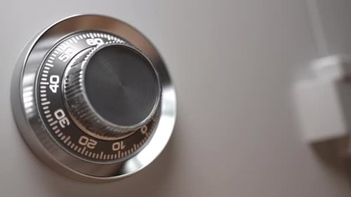 Combination lock on a opening safe door with pack of dollar banknotes inside it. Savings