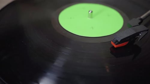 Close up of a Vinyl Record Spinning with green screen croma on vinyl cover.