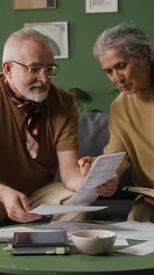 Senior Couple Discussing Finances at Home on a Table
