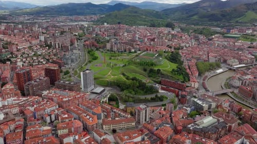 Aerial Establishing Shot of Bilbao City Spain Showing the Dense Urban Landscape with Red Roofs and
