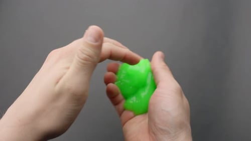 Green Slime Kneaded Between Caucasian Hands, Moving Side to Side
