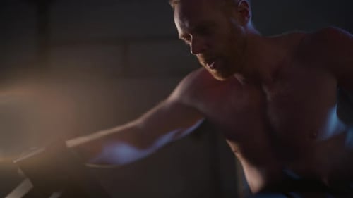 Athletic Man Intensely Exercising On Assault Bike