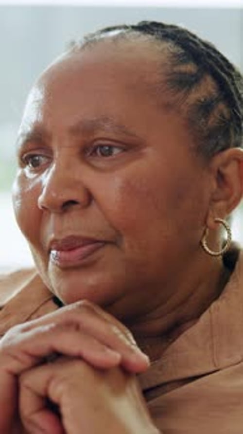 Memory, nostalgia and thinking with senior black woman in home for contemplation or recollection