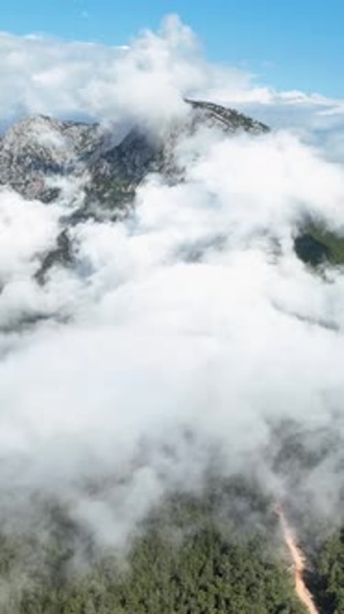Vertical Video Aerial Serenity CloudEnveloped Mountain Scenery