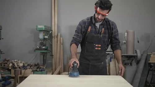 Carpenter is working at workshop.