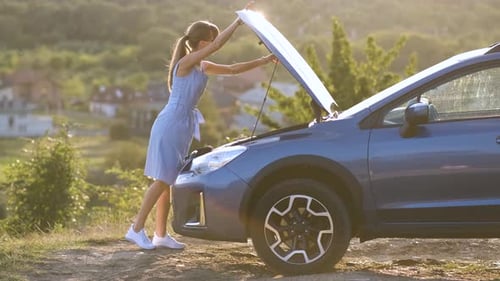 Woman Closes Hood of SUV in Rural Setting