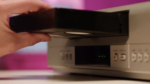 Inserting VHS Tape into Vintage VCR