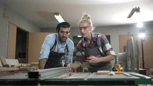 Carpenters are working together at workshop.