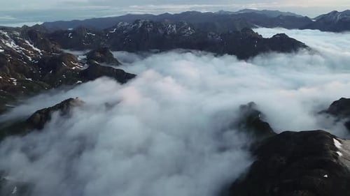Sea of Clouds and High Snowy Mountains – Epic Winter Aerial Scene