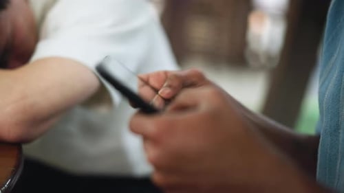 Blurry Hand Tapping Tablet Phone Screen Closeup