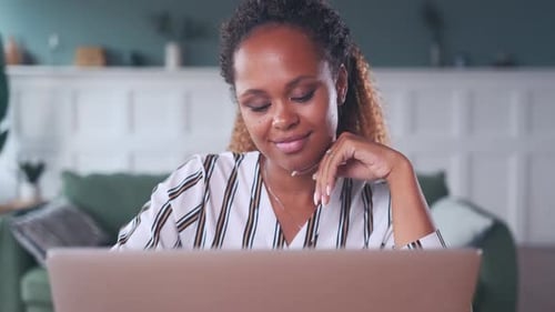 Young Woman Works on Laptop in Her Home