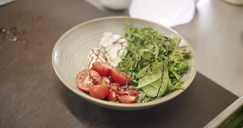 Tasty Salad in a White Plate on a White Background