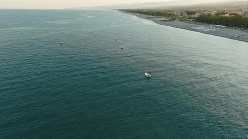 Boats Moored in Front of the Coast