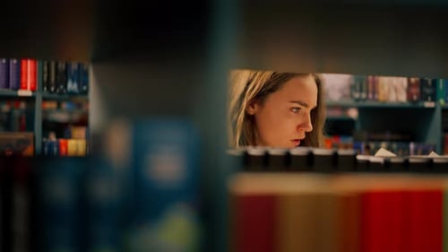 Close Up in a Bookstore Young Girl Chooses a New Book for Herself Preparing for Exams