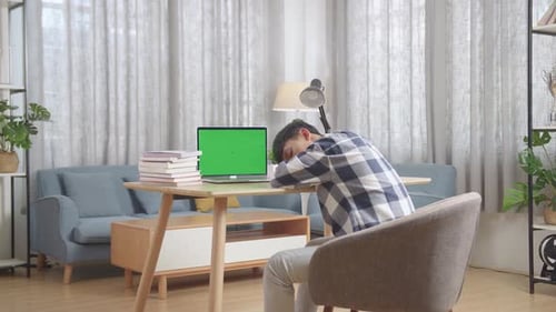 Bored Asian Teenager Student Sleep With Green Mock Up Screen Laptop At Home