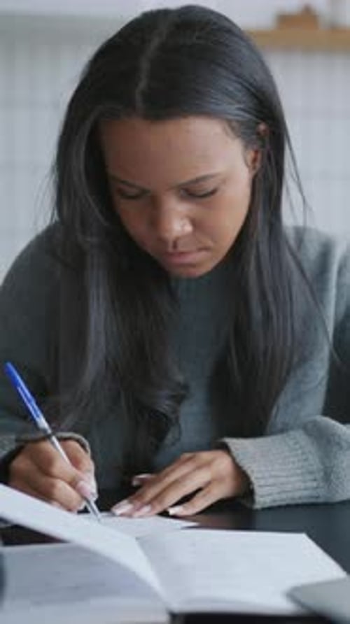 Online Education and Freelance Work at Home Black Woman Writing on Paper African American Female