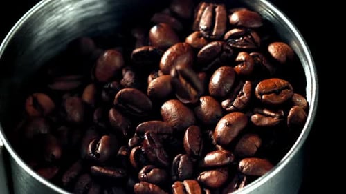 Roasted Coffee Beans Being Poured into Container