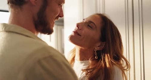 Intimate Couple Embracing in Golden Light Indoors