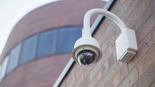 Close-Up of Modern Security Camera Mounted on Brick Wall