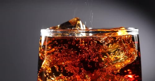 Refreshing Cola Drink with Ice Close Up