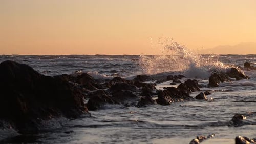 Wild sea with crashing waves during beautiful sunset at ocean