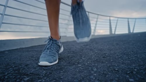 Sneakers, ground and feet with steps on bridge, outdoor cardio training