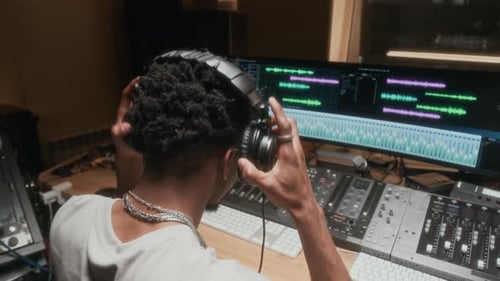 Adult Mixing Music at a Recording Studio